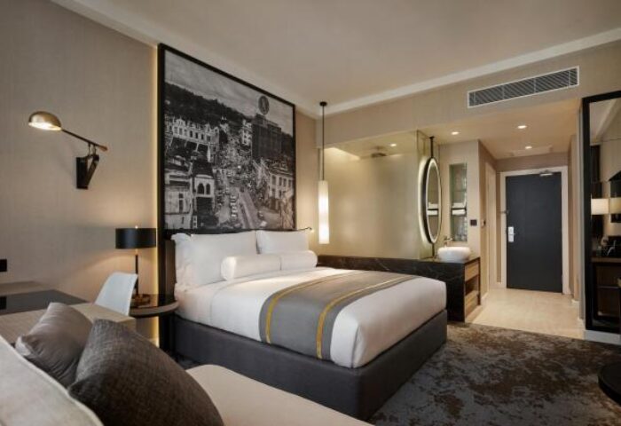 Hotel Stripes Kuala Lumpur, Autograph Collection room. Gay-friendly hotel with a bed, couch, and modern design. Kuala Lumpur hotel room.