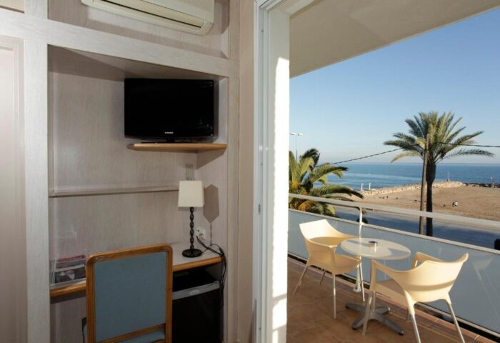 Hotel Subur Maritim room with a balcony view of the beach. Gay-friendly, pet-friendly hotel room with desk, TV, and balcony seating.