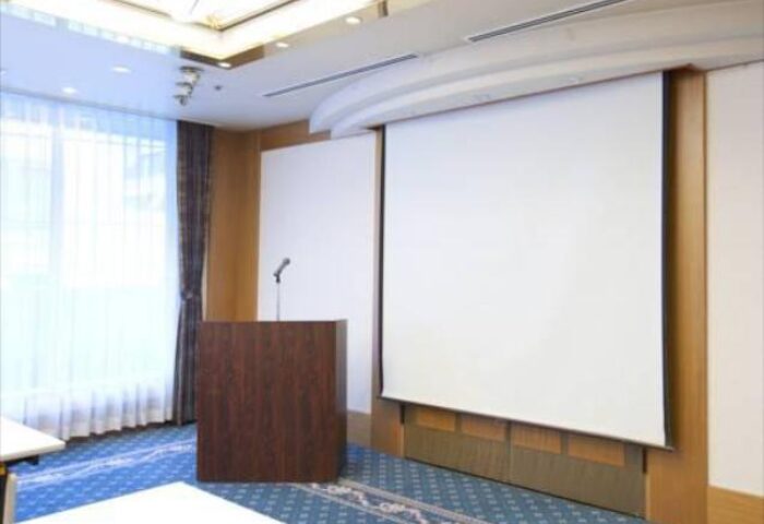 Hotel Sunlite Shinjuku's meeting room. Podium with a microphone and projector screen. Gay-friendly hotel in Shinjuku, Tokyo.