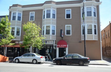 Hotel Sunrise, a gay-friendly hotel on Valencia Street. Brown building with bay windows. A welcoming choice for gay travelers.
