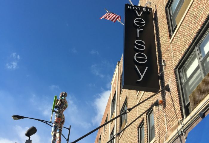 Hotel Versey Chicago Lincoln Park exterior. Gay-friendly hotel with unique art installation. Flags waving in the sky. Brick building.