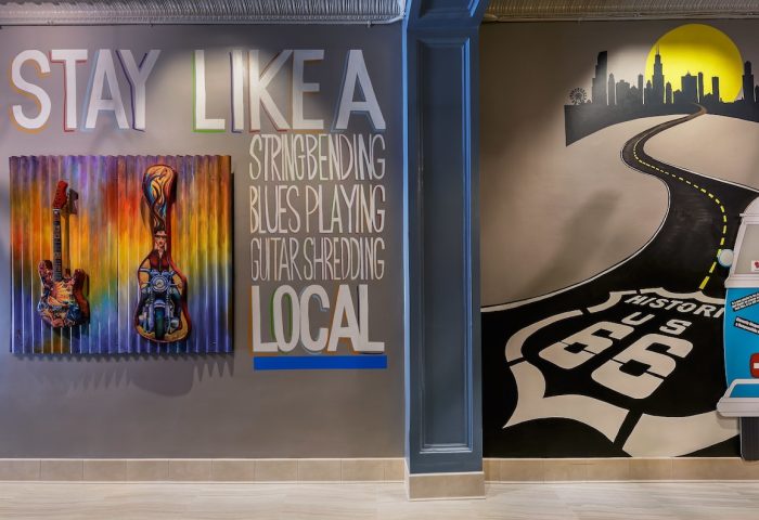 Hotel Versey Chicago Lincoln Park wall art. Guitars, Route 66, & city skyline. Gay-friendly hotel with unique decor for gay travelers.