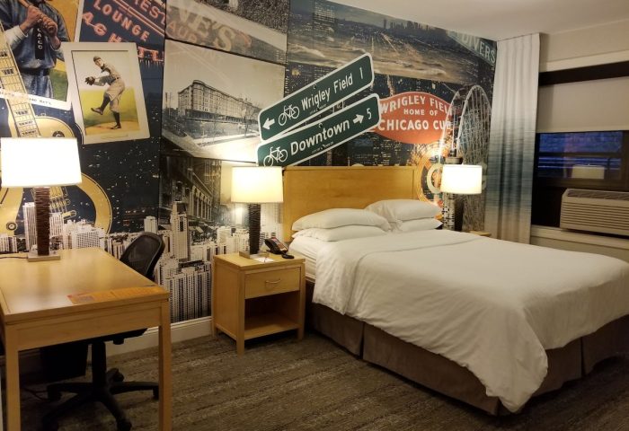 Hotel Versey Chicago Lincoln Park guest room. Gay-friendly hotel decor with a Chicago theme, including Wrigley Field and downtown signs.