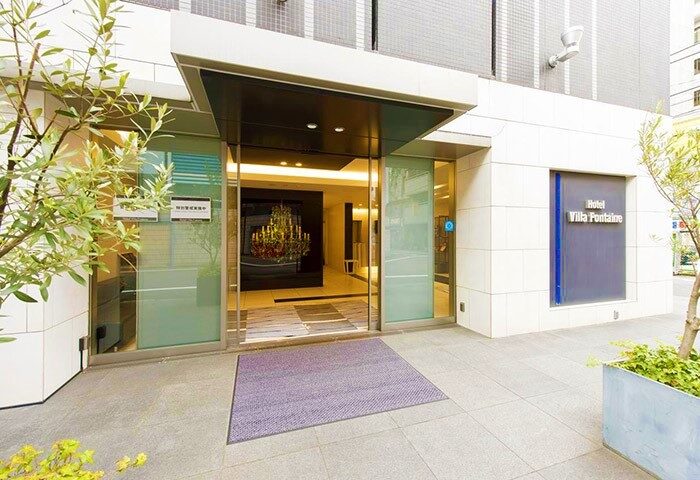 Hotel Villa Fontaine Tokyo-Shinjuku entrance. Gay-friendly hotel with modern design, chandelier, and welcoming atmosphere for gay travelers.