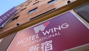 Hotel Wing International Shinjuku signage. Gay-friendly hotel in Shinjuku, Japan. Building exterior with hotel logo.
