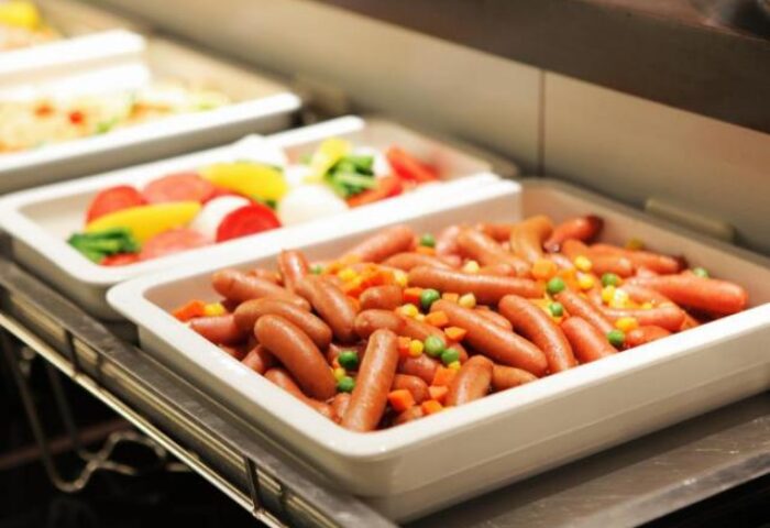 Breakfast buffet at Hotel Wing International Shinjuku, a gay-friendly hotel. Sausages, veggies, and other dishes are available.