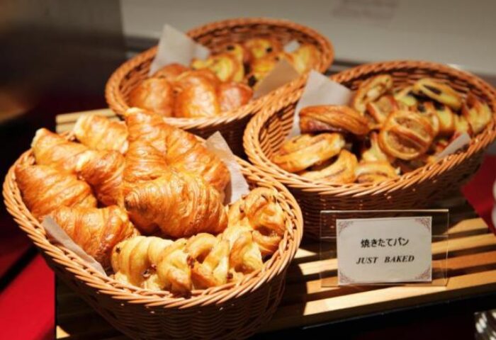 Breakfast pastries at Hotel Wing International Shinjuku, a gay-friendly hotel. Baskets of croissants and baked goods.