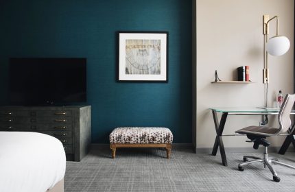 Hotel Zachary, a Tribute Portfolio Hotel, gay-friendly room. Desk, TV, and ottoman in a modern, stylish Chicago hotel room.
