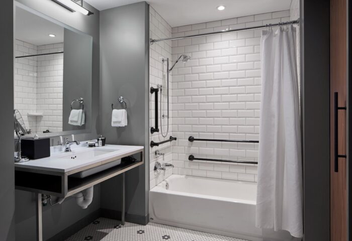 Hotel Zachary Chicago bathroom. Accessible features include grab bars, handheld shower, & roll-under sink. Gay-friendly hotel.