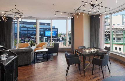 Hotel Zachary, a Tribute Portfolio Hotel, Chicago. Gay-friendly hotel lounge area with chess table and view of Wrigleyville. Interior design.