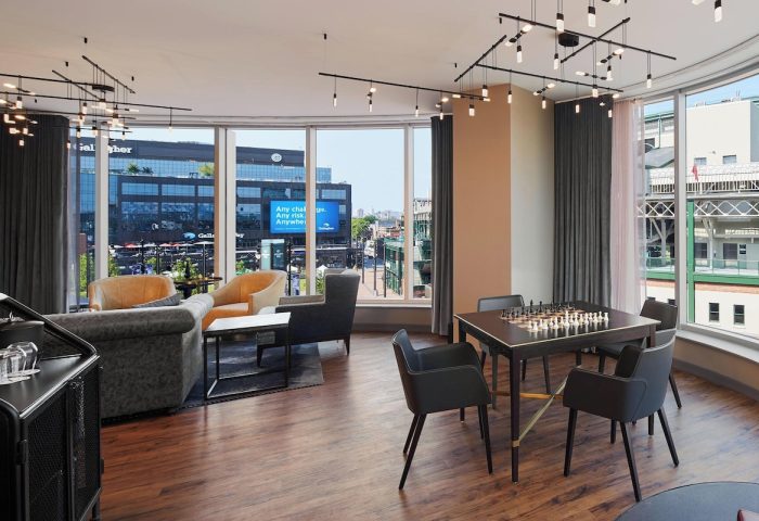 Hotel Zachary, a Tribute Portfolio Hotel, Chicago. Gay-friendly hotel lounge area with chess table and view of Wrigleyville. Interior design.