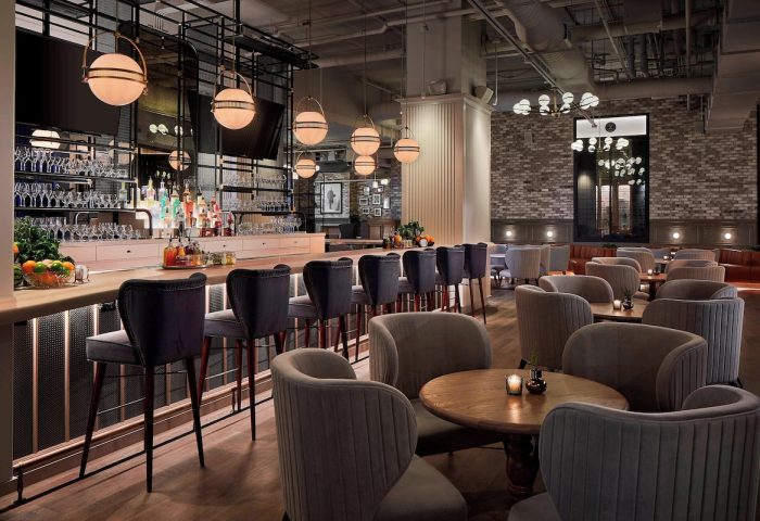 Hotel Zachary, a Tribute Portfolio Hotel in Chicago, gay-friendly. Interior view of the bar and lounge area, stylish seating and lighting.