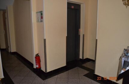 Hotel Zeil's interior: elevator, fire extinguisher, and emergency information. Gay-friendly hotel for gay men, ensuring safety and accessibility.