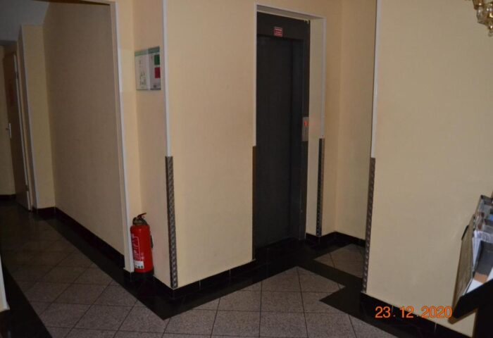 Hotel Zeil's interior: elevator, fire extinguisher, and emergency information. Gay-friendly hotel for gay men, ensuring safety and accessibility.
