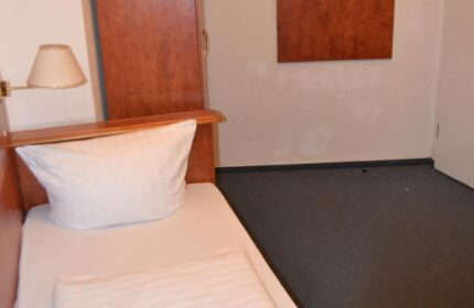 Hotel Zeil gay-friendly room. Single bed, wardrobe, and coat rack. A budget-friendly option for gay travelers in Frankfurt. Hotel Zeil interior.