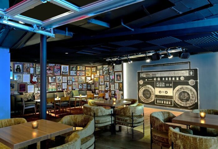 Hotel Ziggy Los Angeles interior. The gay-friendly hotel features a boombox mural, music posters, and cozy seating areas. Cool, retro vibe.