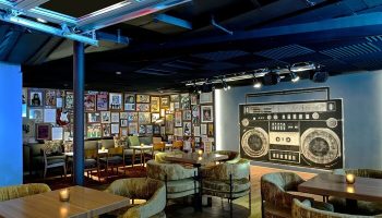 Hotel Ziggy Los Angeles interior. The gay-friendly hotel features a boombox mural, music posters, and cozy seating areas. Cool, retro vibe.