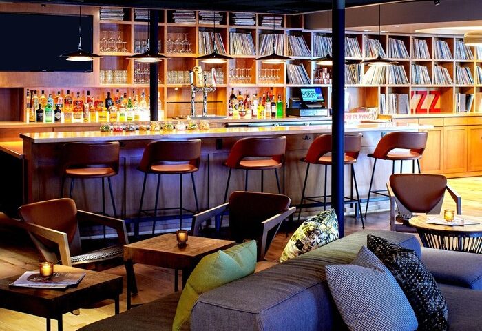 Hotel Ziggy Los Angeles bar area. Stylish, gay-friendly hotel with a bar, stools, and lounge seating. Records line the shelves. Cool design.