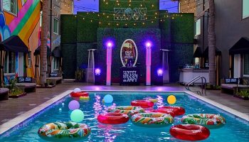 Hotel Ziggy Los Angeles pool view. Gay-friendly hotel with colorful floats, lights, and bar. A vibrant, fun, and welcoming travel spot.