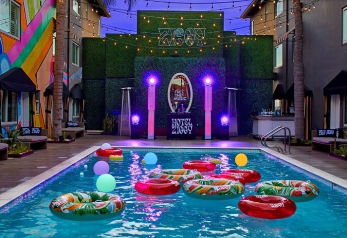 Hotel Ziggy Los Angeles pool view. Gay-friendly hotel with colorful floats, lights, and bar. A vibrant, fun, and welcoming travel spot.
