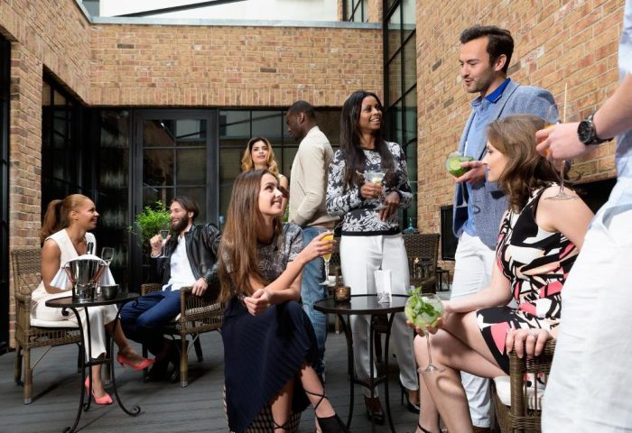 Hotel Zoo Berlin's courtyard: Guests enjoy drinks. This gay-friendly, pet-friendly hotel offers a stylish, social atmosphere. Berlin travel.
