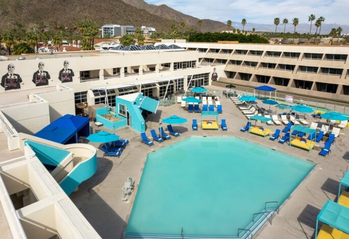 Hotel Zoso, a gay-friendly hotel. Aerial view of the pool area with blue umbrellas and lounge chairs. A cool place to relax and meet people.