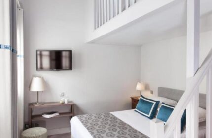 Hotel de la Place du Louvre gay-friendly room. Pet-friendly hotel with a bed, TV, and loft. Perfect for gay travel in Paris.