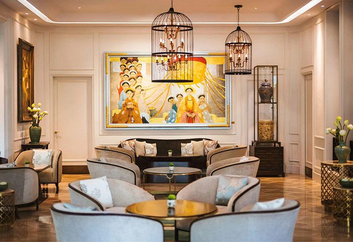 Hôtel des Arts Saigon, a Gay-Friendly Hotel MGallery Collection. Elegant lounge area with stylish seating, art, and birdcage chandeliers.