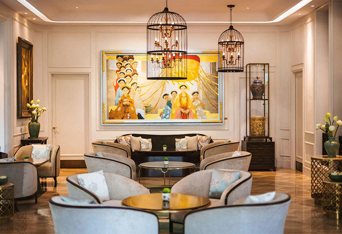 Hôtel des Arts Saigon, a Gay-Friendly Hotel MGallery Collection. Elegant lounge area with stylish seating, art, and birdcage chandeliers.