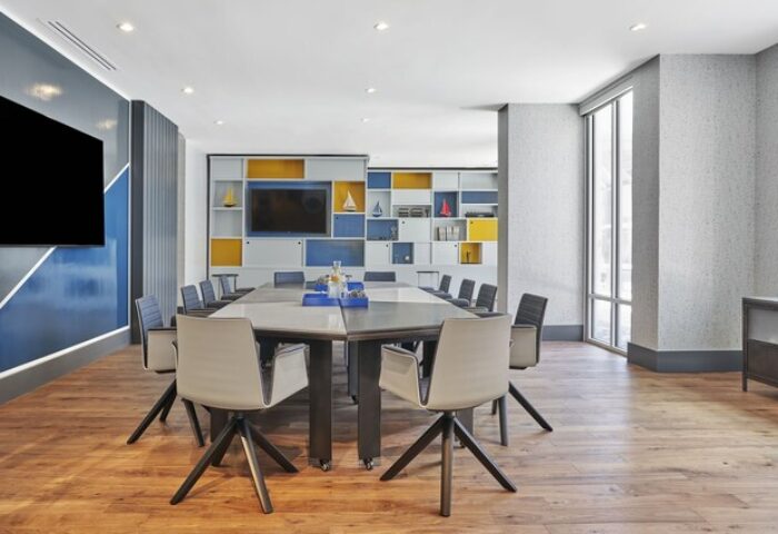 Hyatt Centric The Pike Long Beach meeting room. Gay-friendly hotel conference space with a large table, chairs, and modern decor.