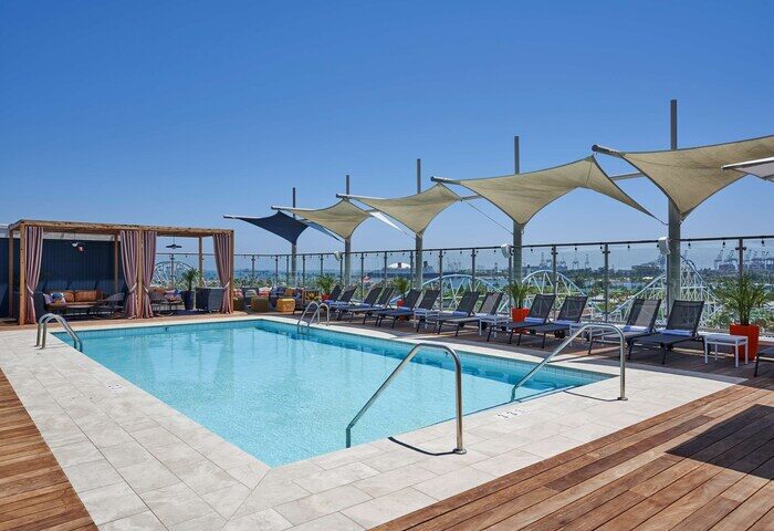 Rooftop pool at the gay-friendly Hyatt Centric The Pike Long Beach hotel. Lounge chairs, cabana, and harbor views. Great for gay travelers.
