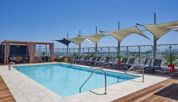 Rooftop pool at the gay-friendly Hyatt Centric The Pike Long Beach hotel. Lounge chairs, cabana, and harbor views. Great for gay travelers.