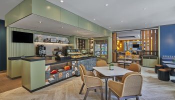 Hyatt Centric The Pike Long Beach's cafe. Gay-friendly hotel with pastries, drinks, and seating. A welcoming space for LGBTQ+ travelers.
