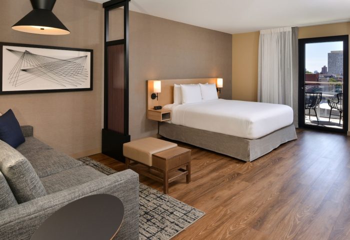 Hyatt Place Chicago/Wicker Park gay-friendly hotel room. King bed, sofa, balcony, modern decor. Ideal for gay travelers in Chicago.