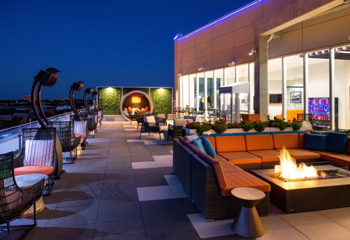 Hyatt Place Chicago/Wicker Park rooftop patio at night. Gay-friendly hotel with fire pit, seating, and city views. Perfect for LGBTQ+ travelers.