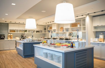 Breakfast buffet at Hyatt Place Montreal Downtown, a gay-friendly hotel. Fresh fruit, plates, and stylish lighting.