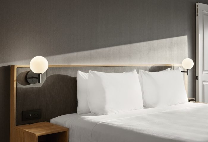 Hyatt Place Montreal Downtown bed with white linens. Gay-friendly hotel room detail. Modern design, perfect for gay travelers in Montreal.