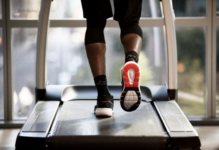 Hyatt Place Montreal Downtown gym: Man exercising on a treadmill. Gay-friendly hotel fitness center in Montreal.