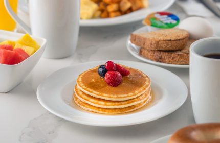 Breakfast at Hyatt Place Montreal Downtown, a gay-friendly hotel. Enjoy pancakes, waffles, fruit, eggs, toast, and coffee.