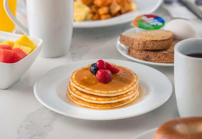 Breakfast at Hyatt Place Montreal Downtown, a gay-friendly hotel. Enjoy pancakes, waffles, fruit, eggs, toast, and coffee.