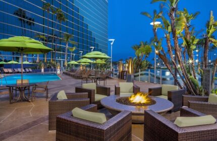 Hyatt Regency Long Beach gay-friendly hotel outdoor area. Pool, fire pit, and lounge chairs. Perfect for gay men's travel in Long Beach, CA.
