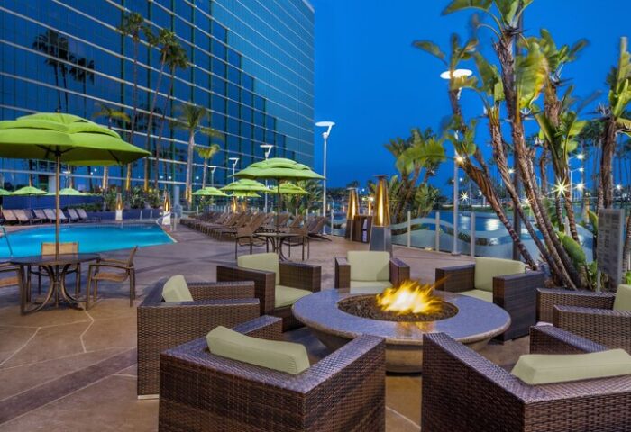 Hyatt Regency Long Beach gay-friendly hotel outdoor area. Pool, fire pit, and lounge chairs. Perfect for gay men's travel in Long Beach, CA.