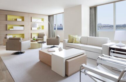 Hyatt Regency Long Beach hotel suite. Modern living room with sofa, chairs, and city view. Gay-friendly hotel for gay men travel.