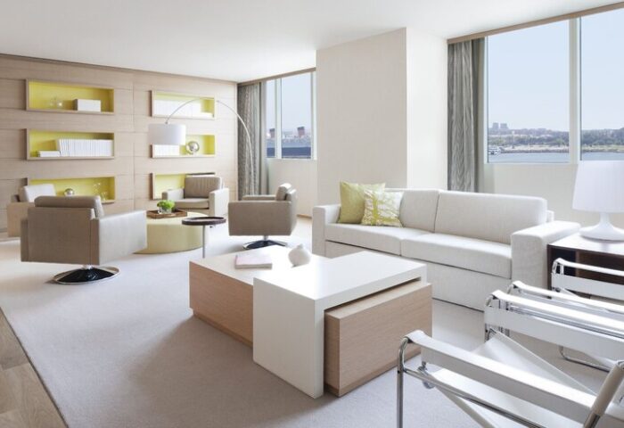 Hyatt Regency Long Beach hotel suite. Modern living room with sofa, chairs, and city view. Gay-friendly hotel for gay men travel.