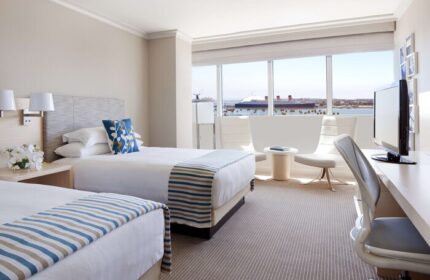 Hyatt Regency Long Beach hotel room with two beds, a desk, and a view of the harbor. Gay-friendly hotel for gay men travel.