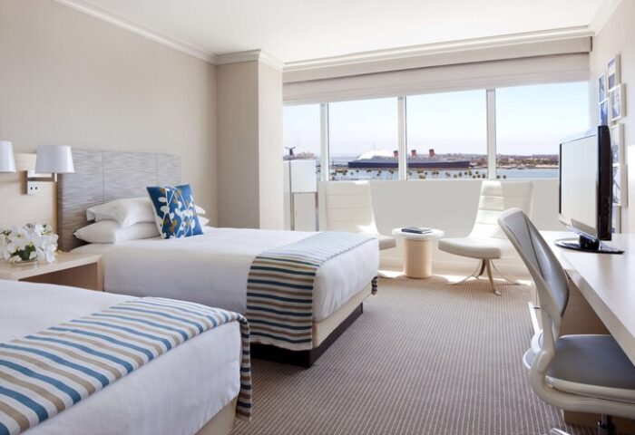 Hyatt Regency Long Beach hotel room with two beds, a desk, and a view of the harbor. Gay-friendly hotel for gay men travel.