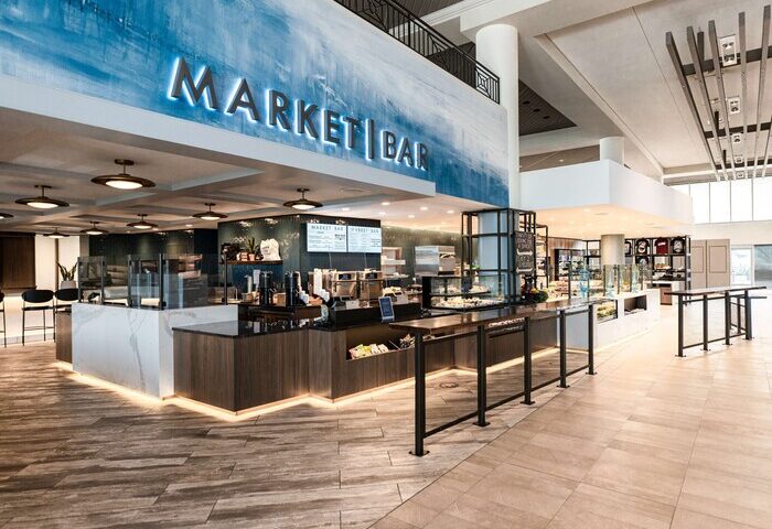Hyatt Regency Long Beach's Market Bar. Modern interior design with a blue accent wall and a well-stocked bar. Gay-friendly hotel.