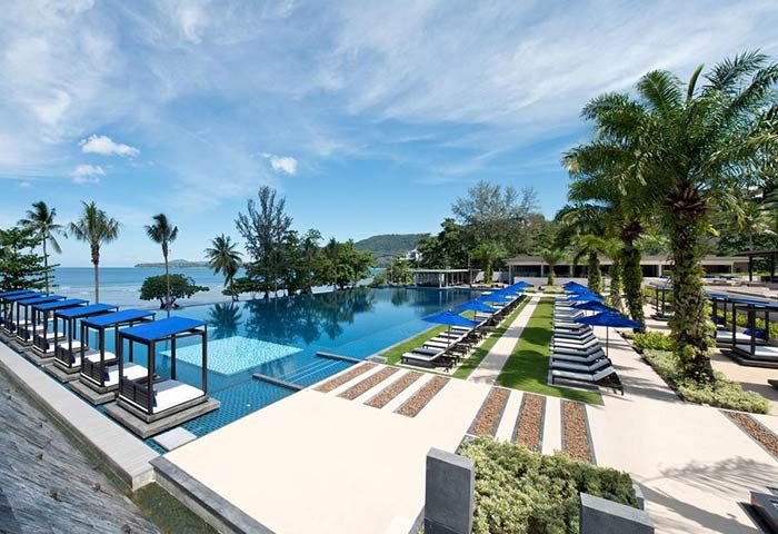 Hyatt Regency Phuket Resort pool. Gay-friendly hotel with ocean view, sunbeds, and palm trees. Ideal for gay men's travel in Phuket, Thailand.
