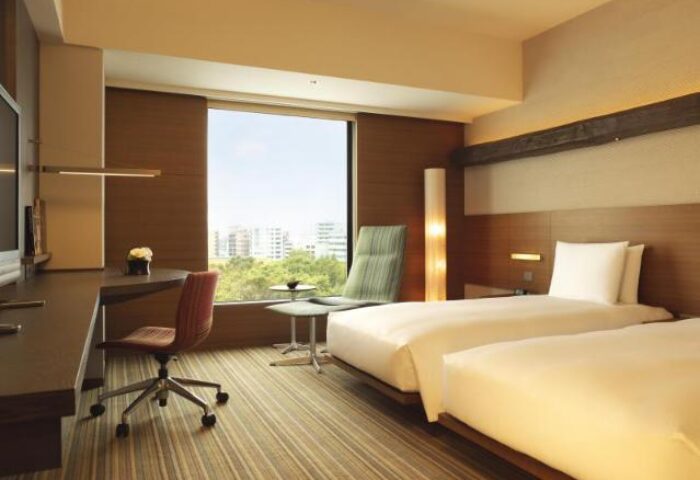 Hyatt Regency Tokyo's gay-friendly hotel room. Two beds, desk, chair and a view. Modern decor for gay men travelers in Japan.