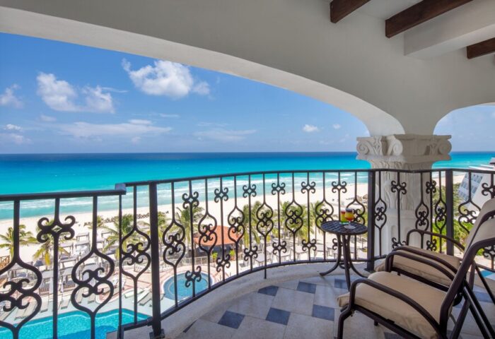 Hyatt Zilara Cancun balcony view. Gay-friendly hotel with ocean view, chairs, and a cocktail. Perfect for LGBTQ+ travelers in Cancun.